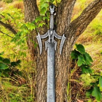 Luciender Sword of Light Replica embedded vertically in forest soil with tree trunk backdrop and fantasy ambiance