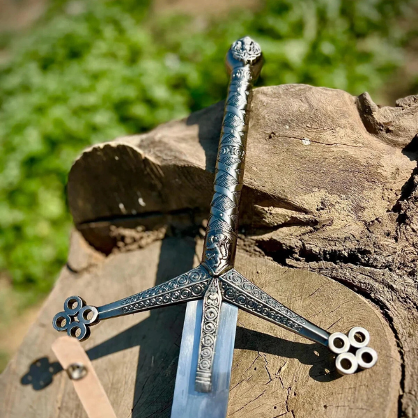 Close-up of the Handmade Scottish Claymore Sword by Ashblades showing genuine leather-wrapped grip and traditional crossguard. Crafted for historical accuracy and ceremonial use Close-up of the Handmade Scottish Claymore Sword by Ashblades showing genuine leather-wrapped grip and traditional crossguard. Crafted for historical accuracy and ceremonial use